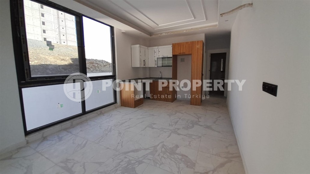 Inexpensive 1+1 apartment, with a total area of 50 m2, 800 meters from the sea, in the Mahmutlar area-id-7027-photo-2
