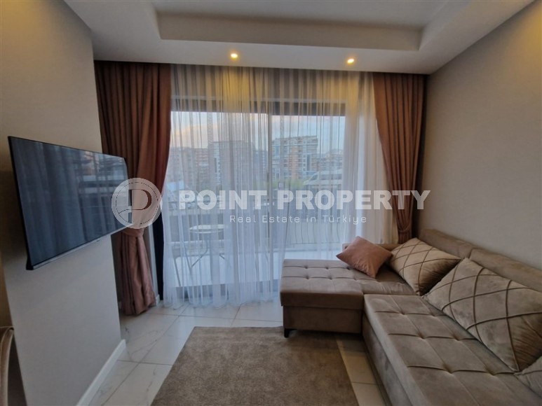 Современная, благоустроенная квартира 1+1, общей площадью 48 м2, в центре спокойного, уютного района Аланьи - Тосмур-id-7119-фото-2