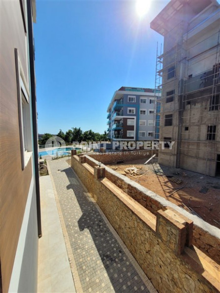 Two bedroom apartment, 90m² in a complex with a swimming pool under construction, in Alanya - Oba-id-1566-photo-11
