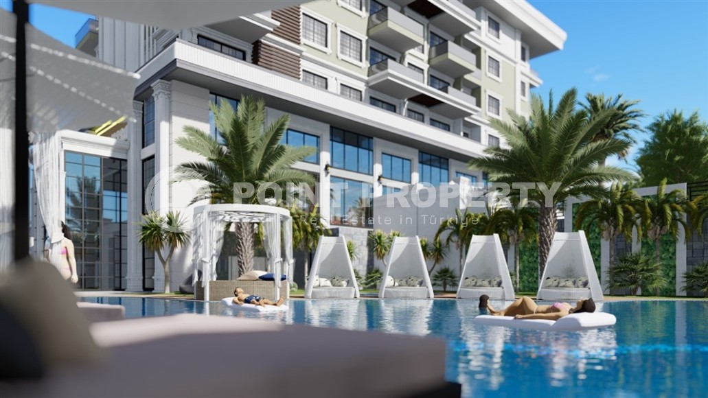 Новые апартаменты 1+1 в здании на этапе строительства в 200 метрах от моря в центре района Каргыджак.-id-4123-фото-1