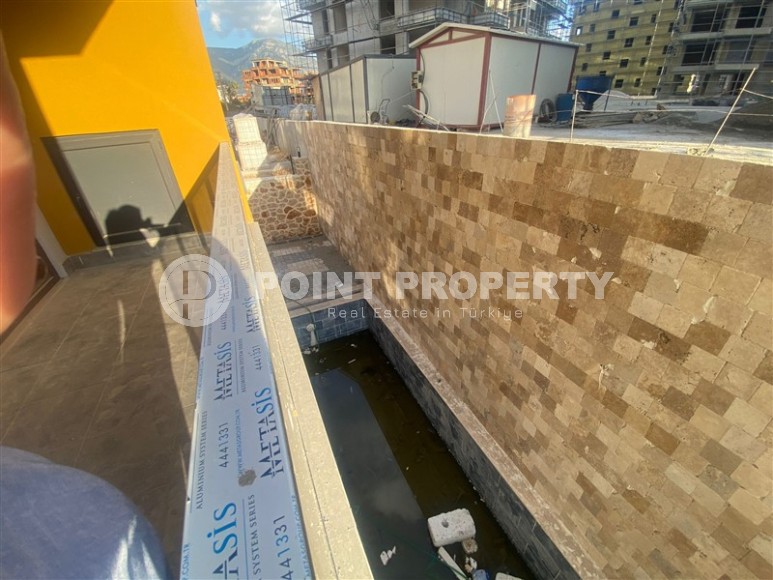 Небольшая новая квартира с чистовой отделкой в 350 метрах от моря, в центре спокойного района Аланьи - Тосмур-id-7383-фото-9