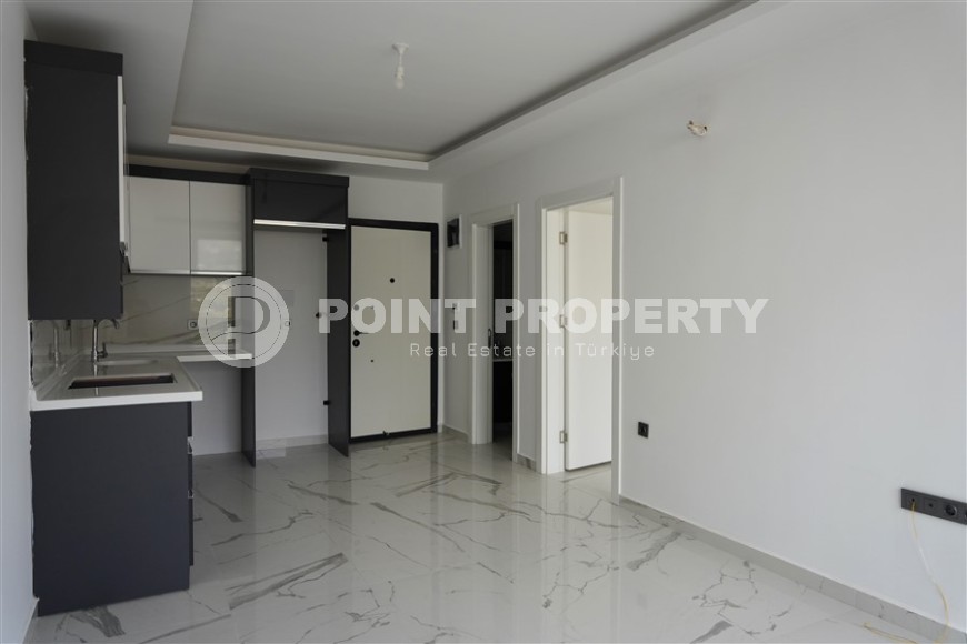 Компактная новая квартира с чистовой отделкой, в нескольких минутах ходьбы от центра популярного района Аланьи -  Махмутлар-id-7513-фото-2