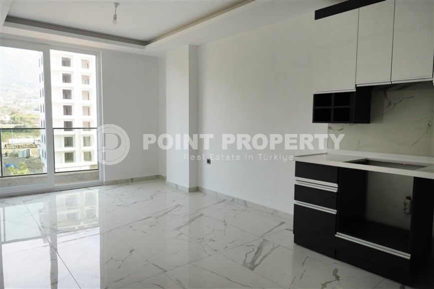 Компактная новая квартира с чистовой отделкой, в нескольких минутах ходьбы от центра популярного района Аланьи -  Махмутлар-id-7513-фото-3