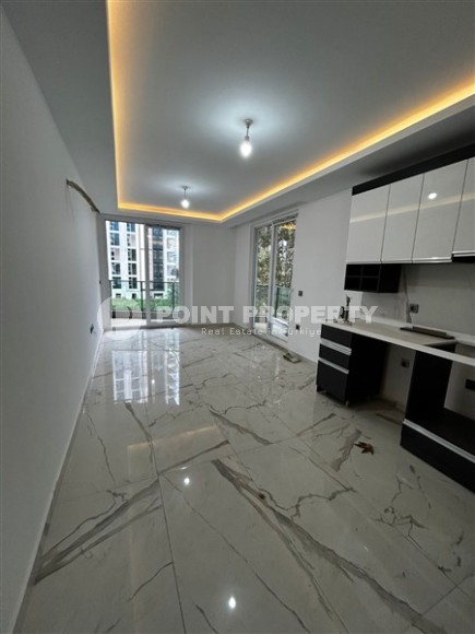 Новая квартира в центре района Махмутлар, на 1-м этаже в жилом комплексе, введенном в эксплуатацию в 2023 году-id-7946-фото-2