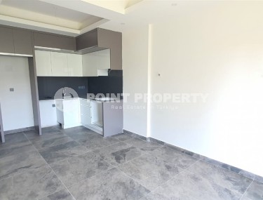 Небольшая новая квартира с чистовой отделкой в 650 метрах от моря, в центре популярного района Аланьи - Махмутлар-id-7310-фото-2