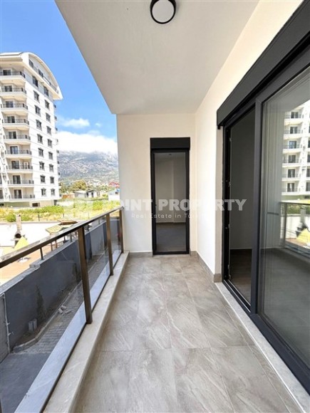 Просторная квартира 55 м² в новом комплексе в Махмутларе-id-8422-фото-11