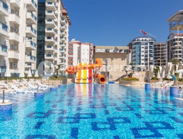 Стильная квартира 56 м² в престижном комплексе в центре Махмутлара-id-8909-фото-1