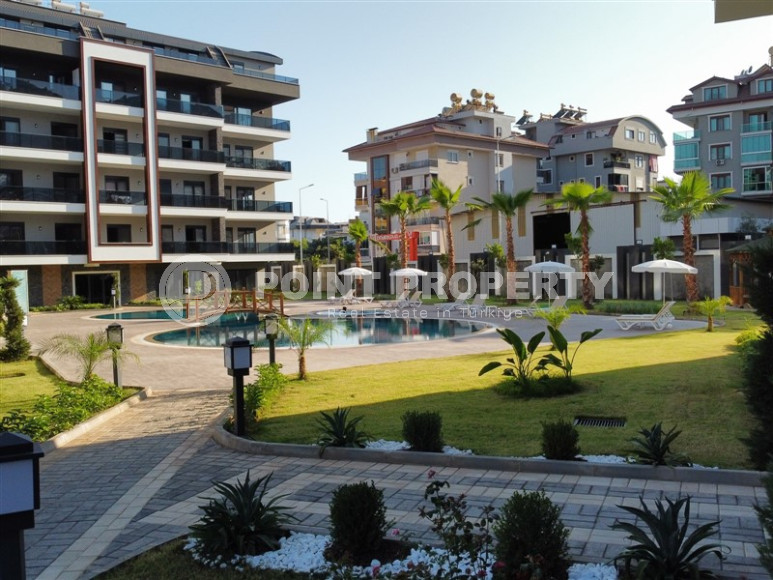 Cozy two-room apartment 1+1 with an area of 52 m2 in a modern residential complex with a private pool in Oba, Alanya-id-1202-photo-2