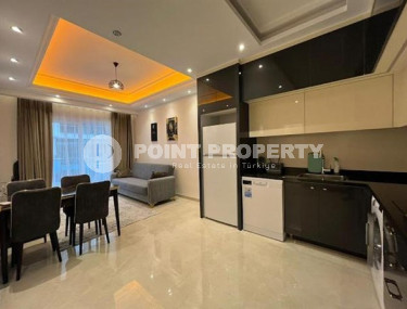 Stylish 1+1 apartment on the 9th floor in a building built in 2022 in the center of Mahmutlar.-id-3906-photo-2