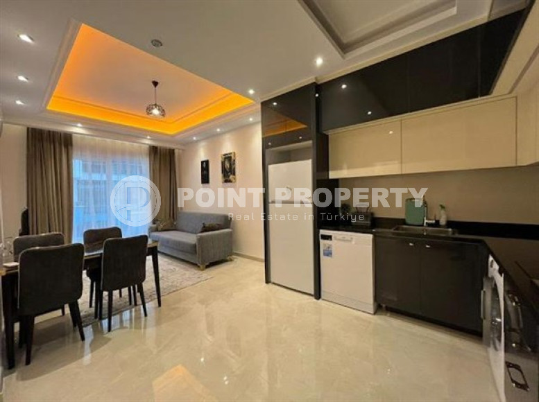 Stylish 1+1 apartment on the 9th floor in a building built in 2022 in the center of Mahmutlar.-id-3906-photo-2