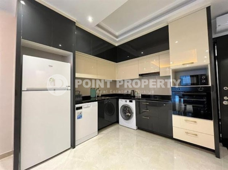 Stylish 1+1 apartment on the 9th floor in a building built in 2022 in the center of Mahmutlar.-id-3906-photo-3