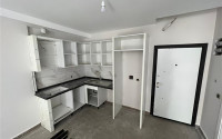 1+1 apartments with fine finishing in a house at the final stage of construction in the center of the popular Mahmutlar area.-id-4162-photo-2