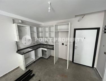 1+1 apartments with fine finishing in a house at the final stage of construction in the center of the popular Mahmutlar area.-id-4162-photo-2