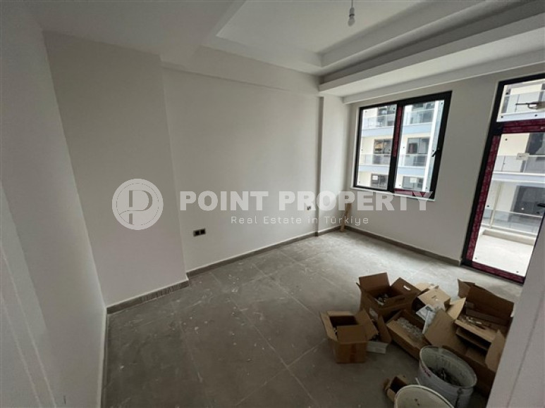 1+1 apartments with fine finishing in a house at the final stage of construction in the center of the popular Mahmutlar area.-id-4162-photo-4
