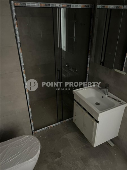 1+1 apartments with fine finishing in a house at the final stage of construction in the center of the popular Mahmutlar area.-id-4162-photo-6