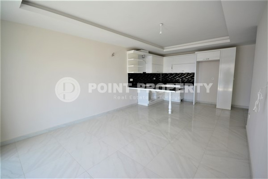 Spacious 1+1 apartments with fine finishing in the center of Mahmutlar and 200 meters from the sea.-id-4344-photo-2