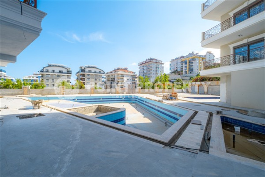 Небольшие апартаменты 1+1 на завершающем этапе строительства в двух километрах от моря в престижном районе Аланьи Оба.-id-4403-фото-8