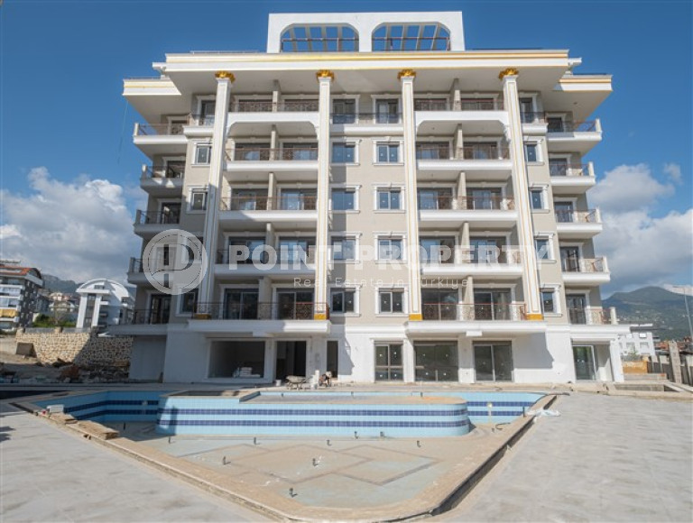 Небольшие апартаменты 1+1 на завершающем этапе строительства в двух километрах от моря в престижном районе Аланьи Оба.-id-4403-фото-9