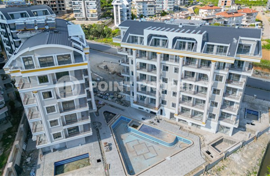 Небольшие апартаменты 1+1 на завершающем этапе строительства в двух километрах от моря в престижном районе Аланьи Оба.-id-4403-фото-10