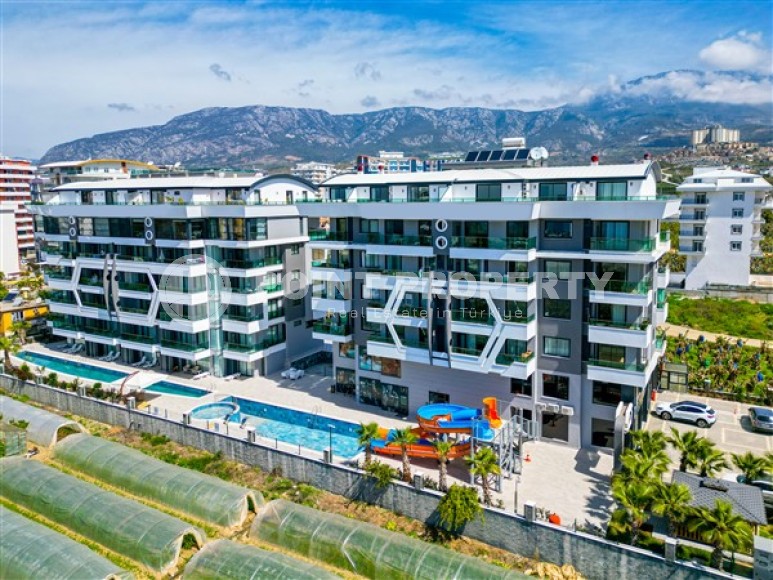 Стильные меблированные апартаменты, планировкой 1+1, рядом с морем в районе Каргыджак-id-5411-фото-17