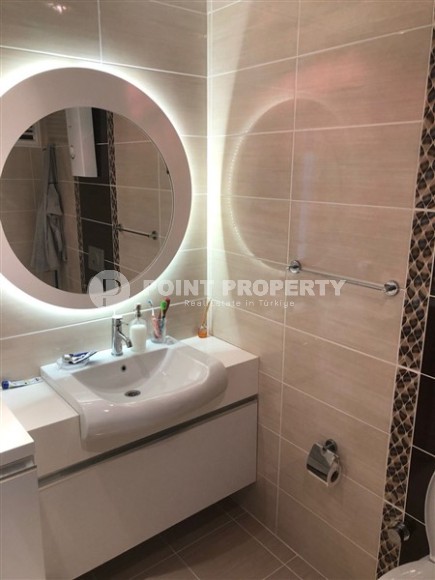 Panoramic apartment 1+1, with a total area of 70 m2, on the 11th floor in the center of Mahmutlar district-id-5422-photo-4