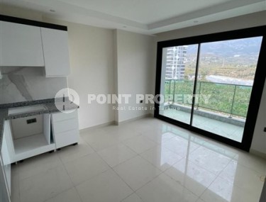 Небольшие апартаменты в чистовой отделке, планировкой 1+1, в районе Махмутлар-id-5485-фото-3